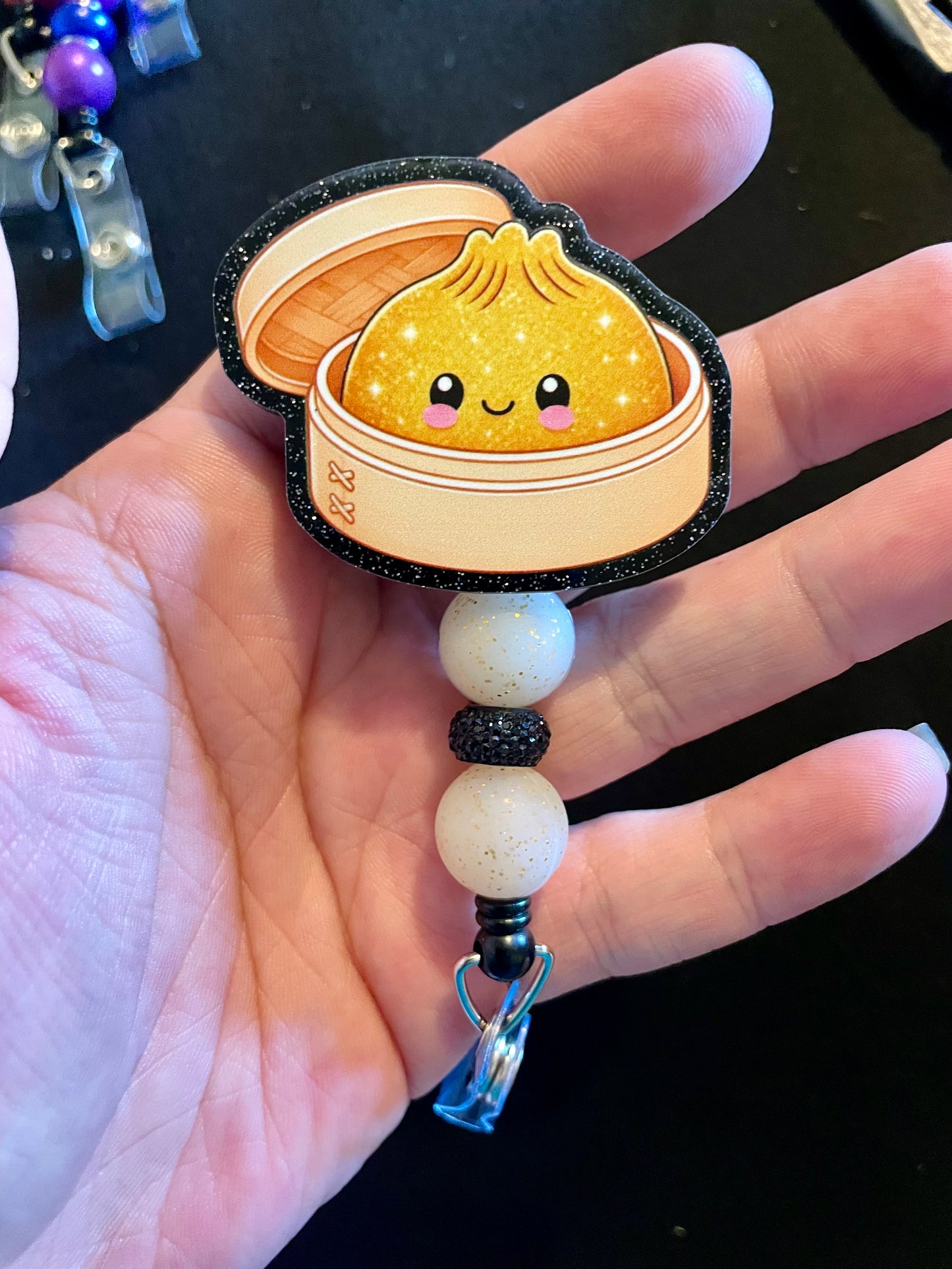 Golden dumpling badge reel