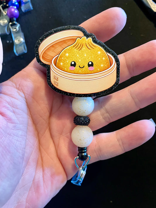 Golden dumpling badge reel