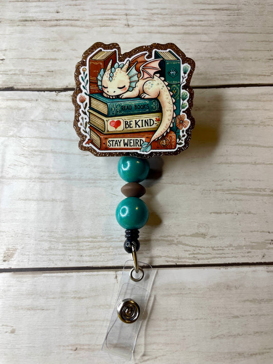 Book stack dragon badge reel