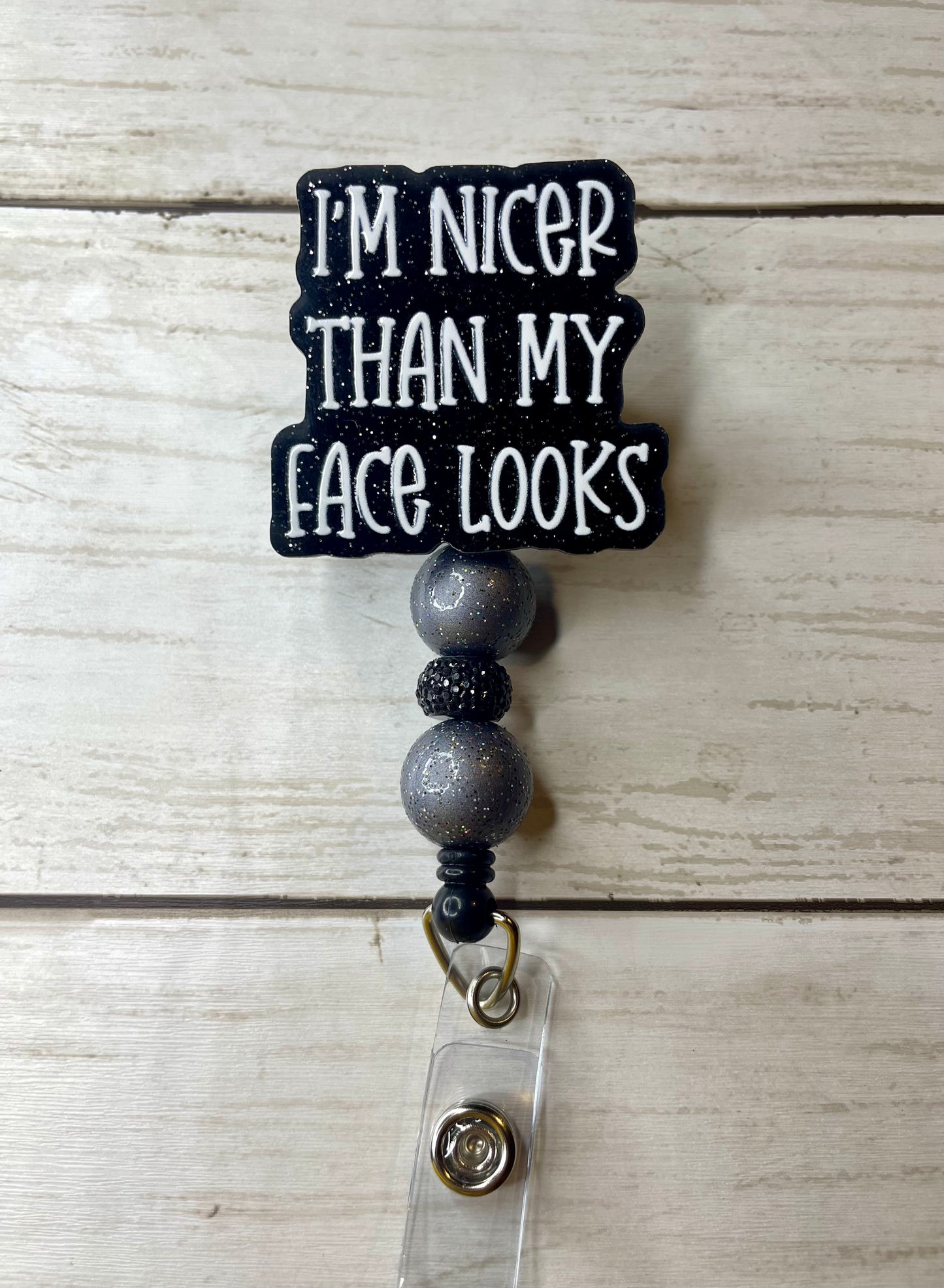 Nicer than my face looks badge reel
